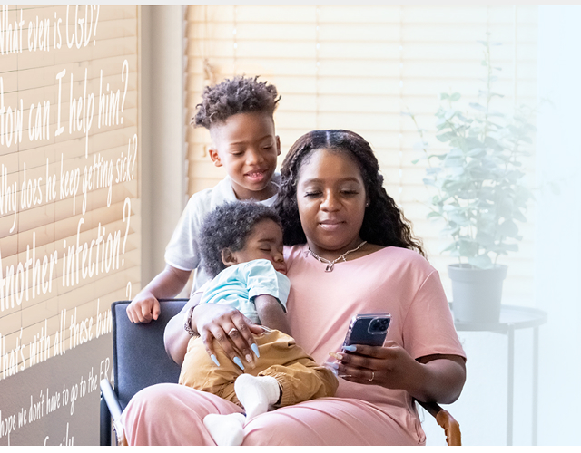 Image of a mother with her two young children, the youngest child has chronic granulomatous disease 